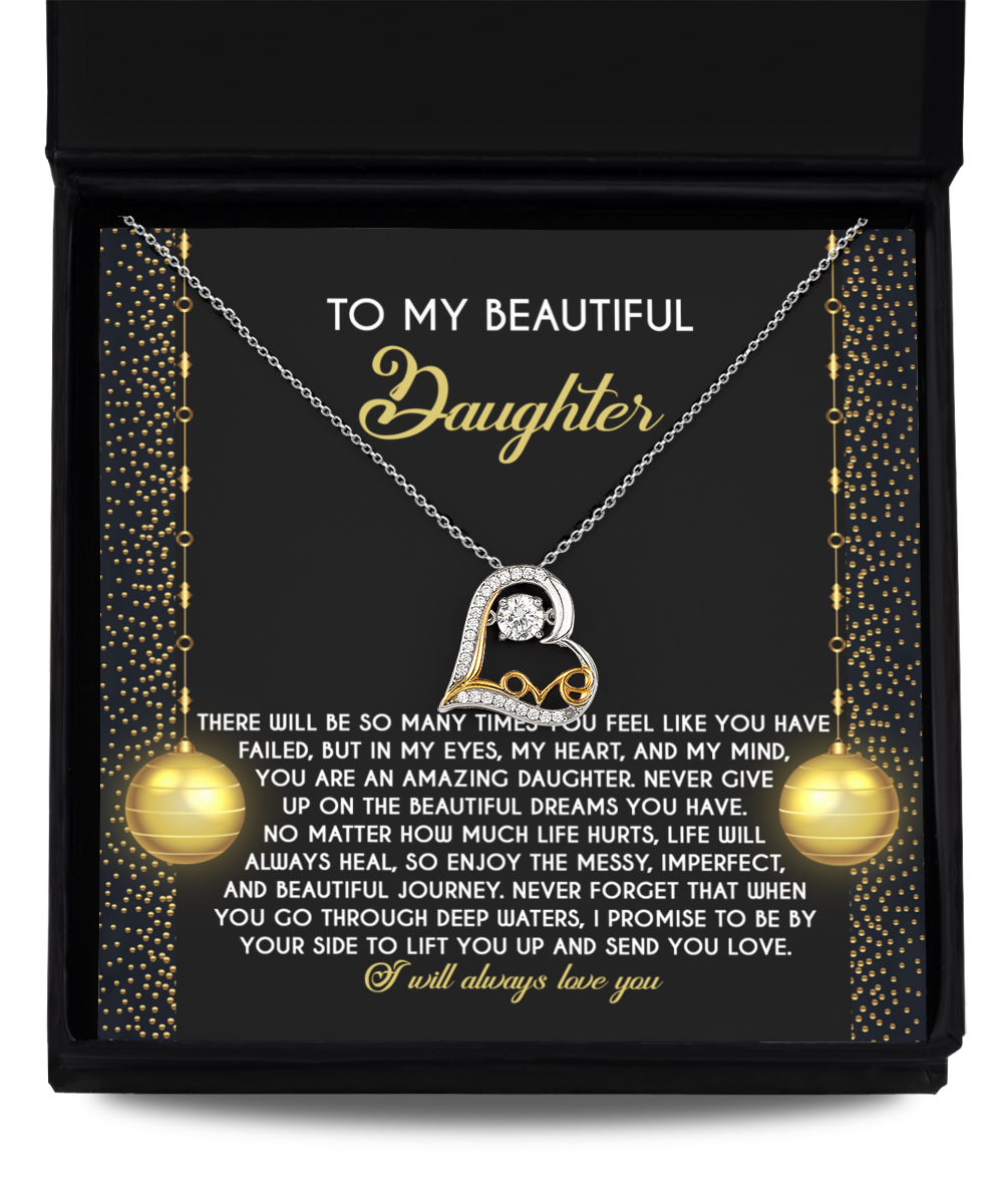 The Daughter-Deep Waters - Love Dancing Necklace, featuring a heart pendant, comes in an elegant box with a heartfelt message for a daughter. Crafted from sterling silver, this stunning piece is designed to celebrate the cherished bond you share and make her feel truly special.