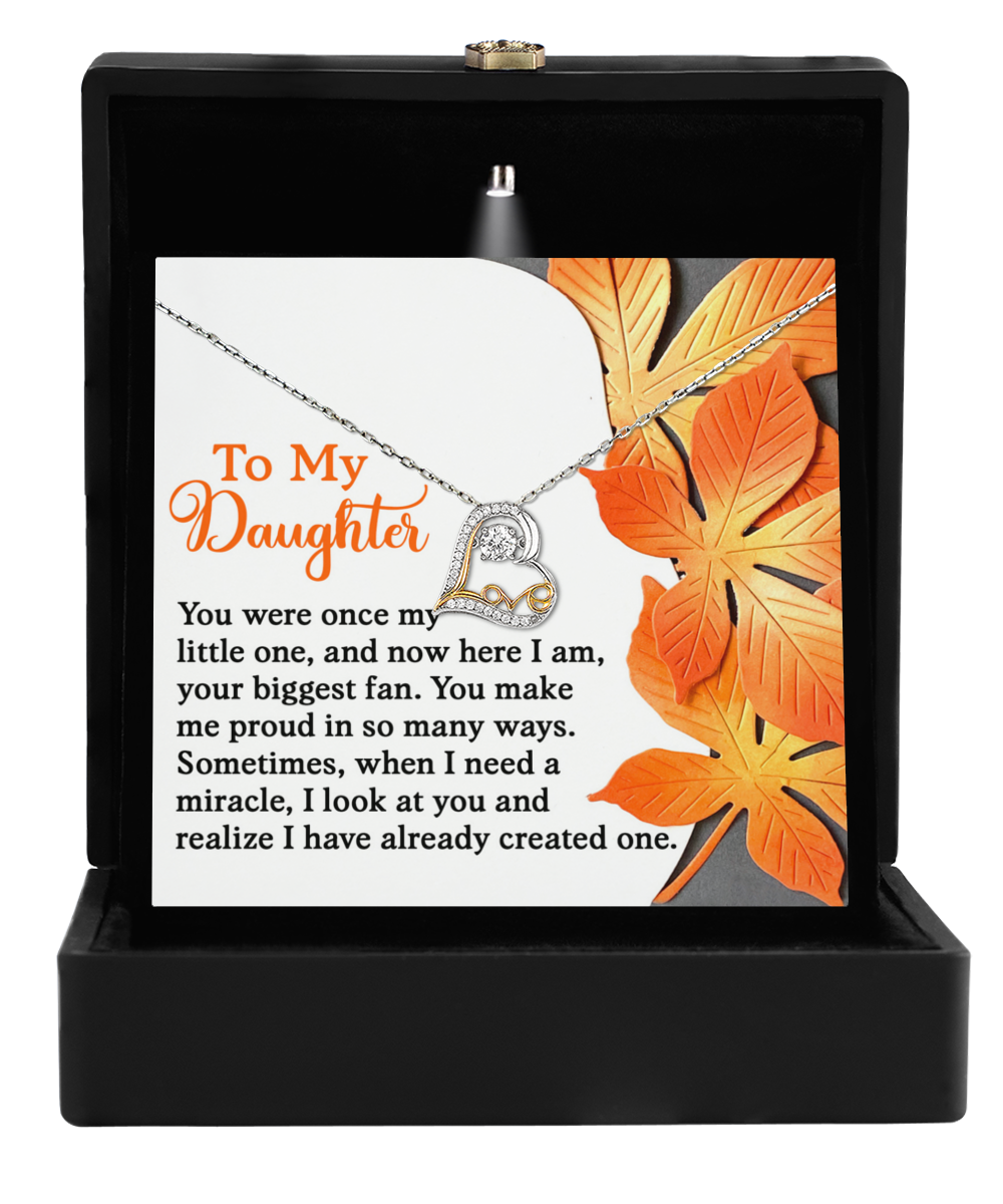 The Daughter-Here I Am - Love Dancing Necklace is presented in a black box adorned with decorative orange leaves and comes with a heartfelt message for a daughter.