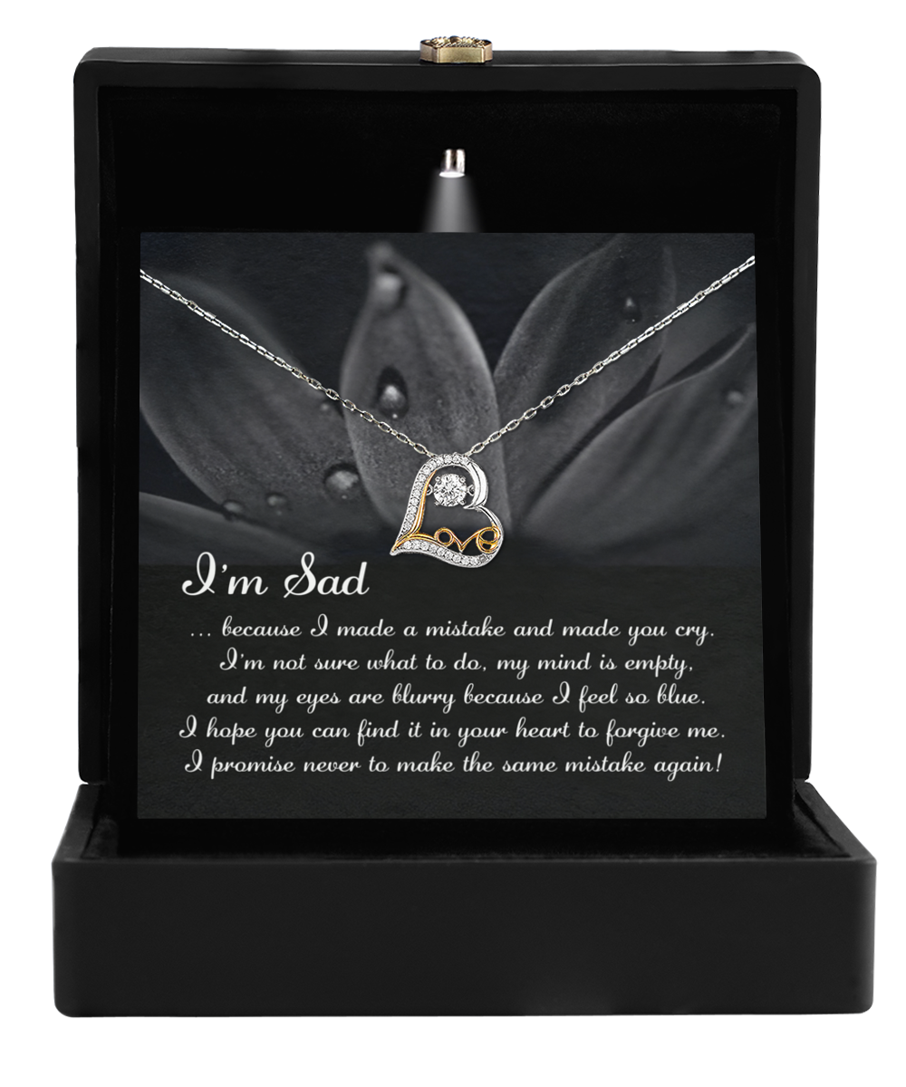 The Sorry-Feel So Blue Love Dancing Necklace, with a heart-shaped pendant nestled in a black box and a message card stating, "I'm Sad... I promise never to make the same mistake again!" is the perfect gift for your wife.