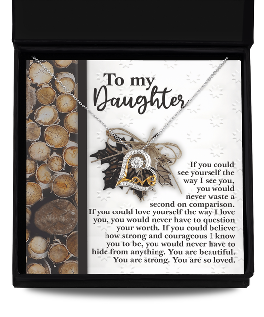 The Daughter-Holds For You 2 - Love Dancing Necklace, crafted in sterling silver and featuring a "LOVE" pendant, is elegantly packaged in a box with a loving message for a daughter.