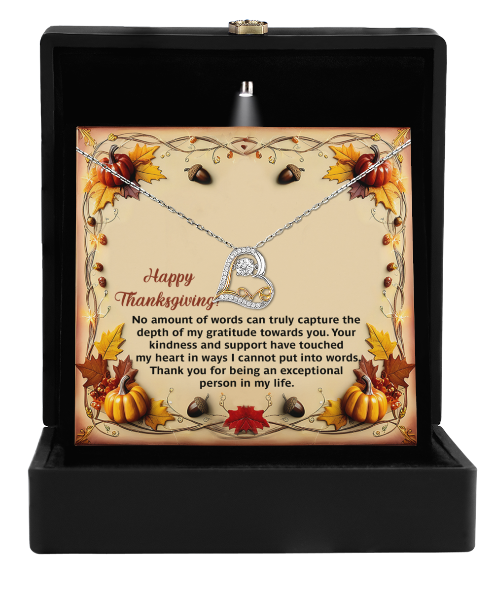 The Thanksgiving-Put Into Words - Love Dancing Necklace showcases a heart pendant embellished with sparkling cubic zirconia, elegantly presented in a black box. The display card is adorned with a Thanksgiving-themed border of pumpkins and acorns, perfectly framing a heartfelt message of gratitude.