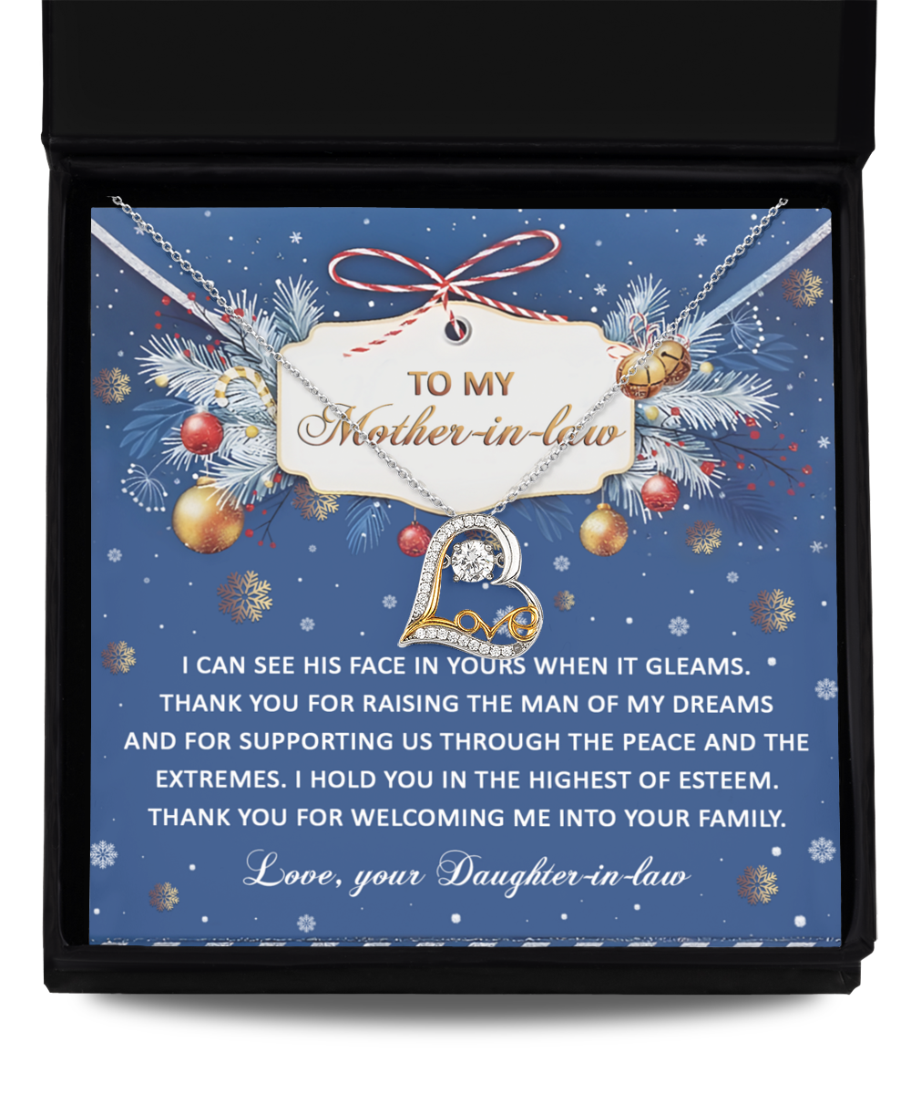 A gift box containing the exquisite Mother-in-law-I Hold You - Love Dancing Necklace paired with a sentimental card that reads "To my Mother-in-law," featuring a heartfelt message signed "Love, your Daughter-in-law." The backdrop showcases a blue theme embellished with festive decorations.