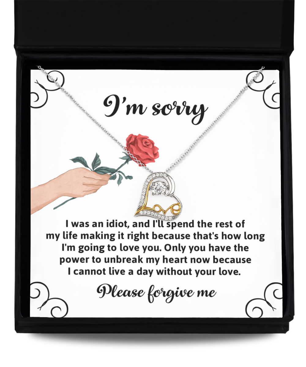 A Sorry-Making It Right - Love Dancing Necklace, featuring a red rose and heart-shaped design crafted in 14k gold, is displayed above an apology note with the text: "I'm sorry. Please forgive me.