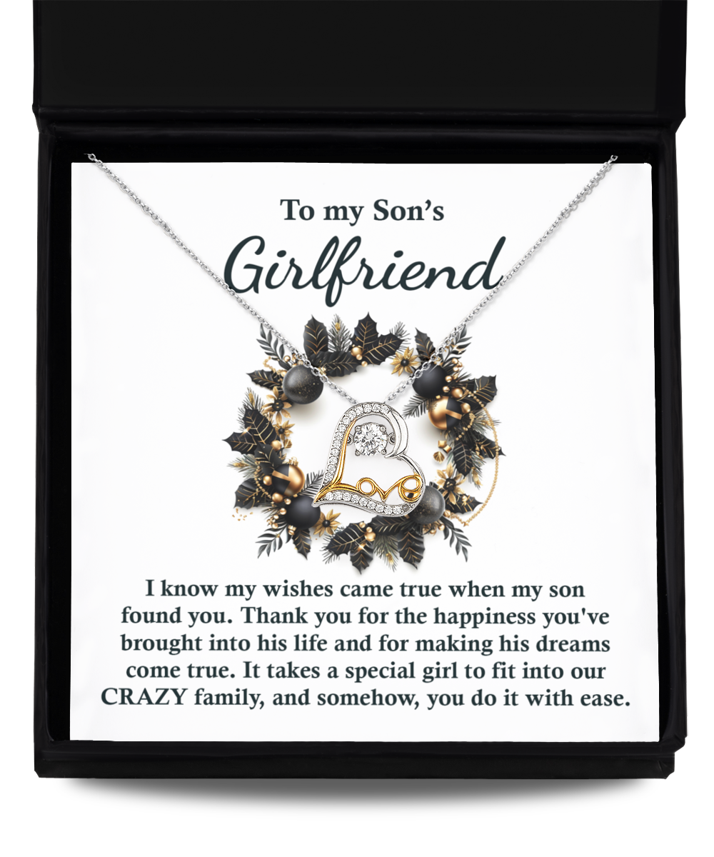 Introducing the Son's Girlfriend- Found You - Love Dancing Necklace, a beautiful piece featuring a heart pendant crafted in sterling silver and presented in an elegant gift box. The lid bears the inscription "To my Son's Girlfriend," along with a touching message celebrating her positive influence on the family.