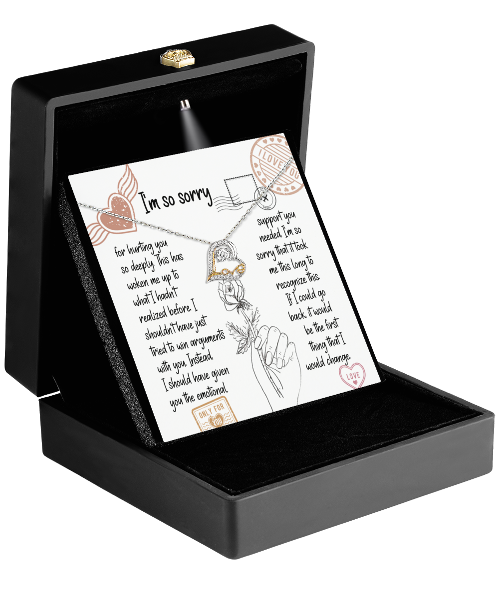 A black box showcases an apology card labeled "I'm so sorry," adorned with decorative elements and a hand illustration holding a heart-shaped pendant, conveying a heartfelt message. This is the Sorry-Emotional Support-Love Dancing Necklace.