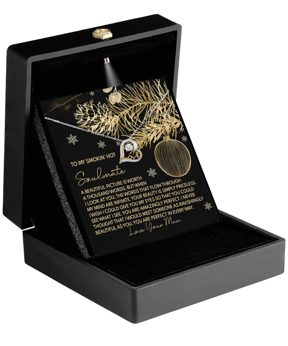 The black jewelry box with an open lid showcases the Soulmate-Amazingly Perfect - Love Dancing Necklace and an insert card adorned with gold holiday-themed decorative elements and a romantic message.