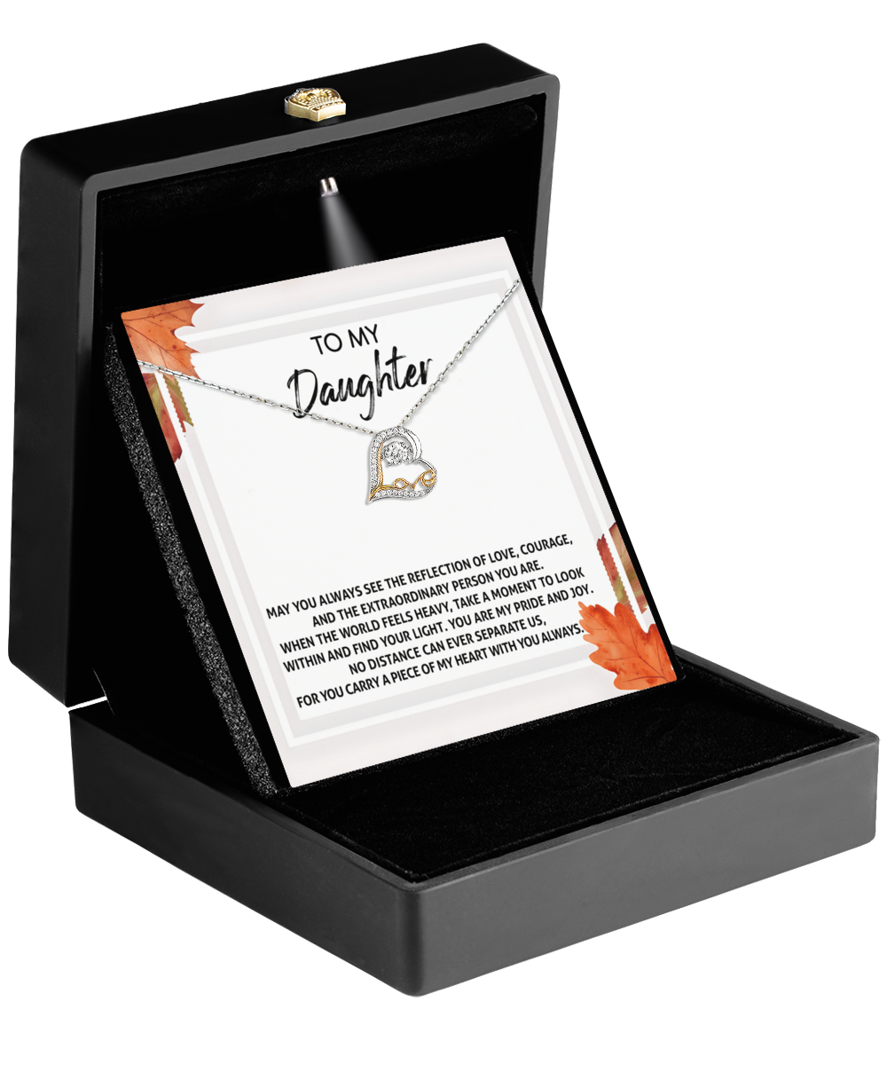 A beautiful 14k gold Daughter-Find Your Light - Love Dancing Necklace elegantly presented in a black box, complete with a card that reads "To My Daughter" and a heartfelt message.