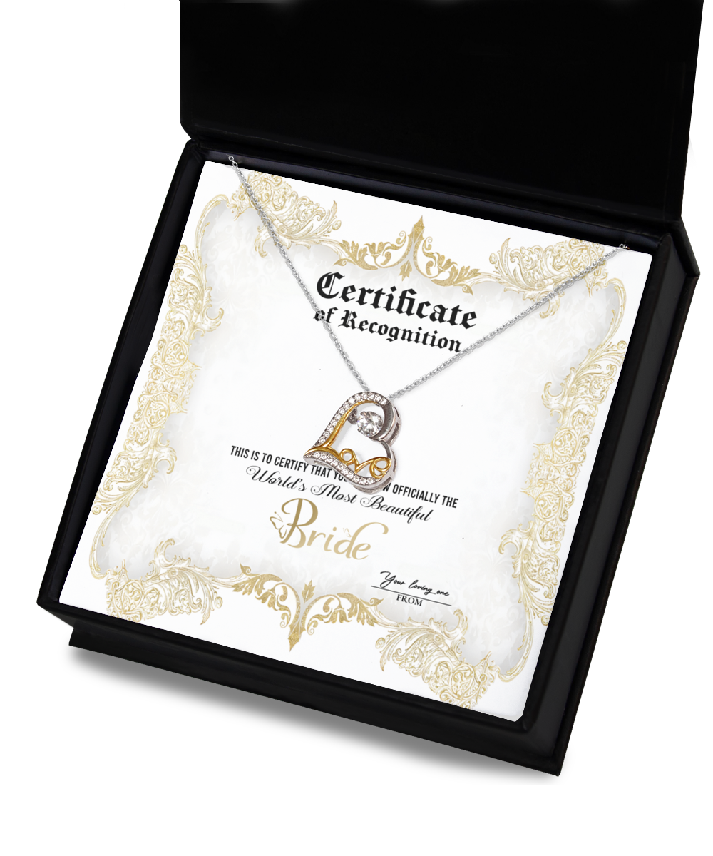 An open black box containing a Bride-Certificate Of Achievement - Love Dancing Necklace and a certificate. The certificate reads, "Certificate of Recognition. World's Most Beautiful Bride," and has a gold decorative border.