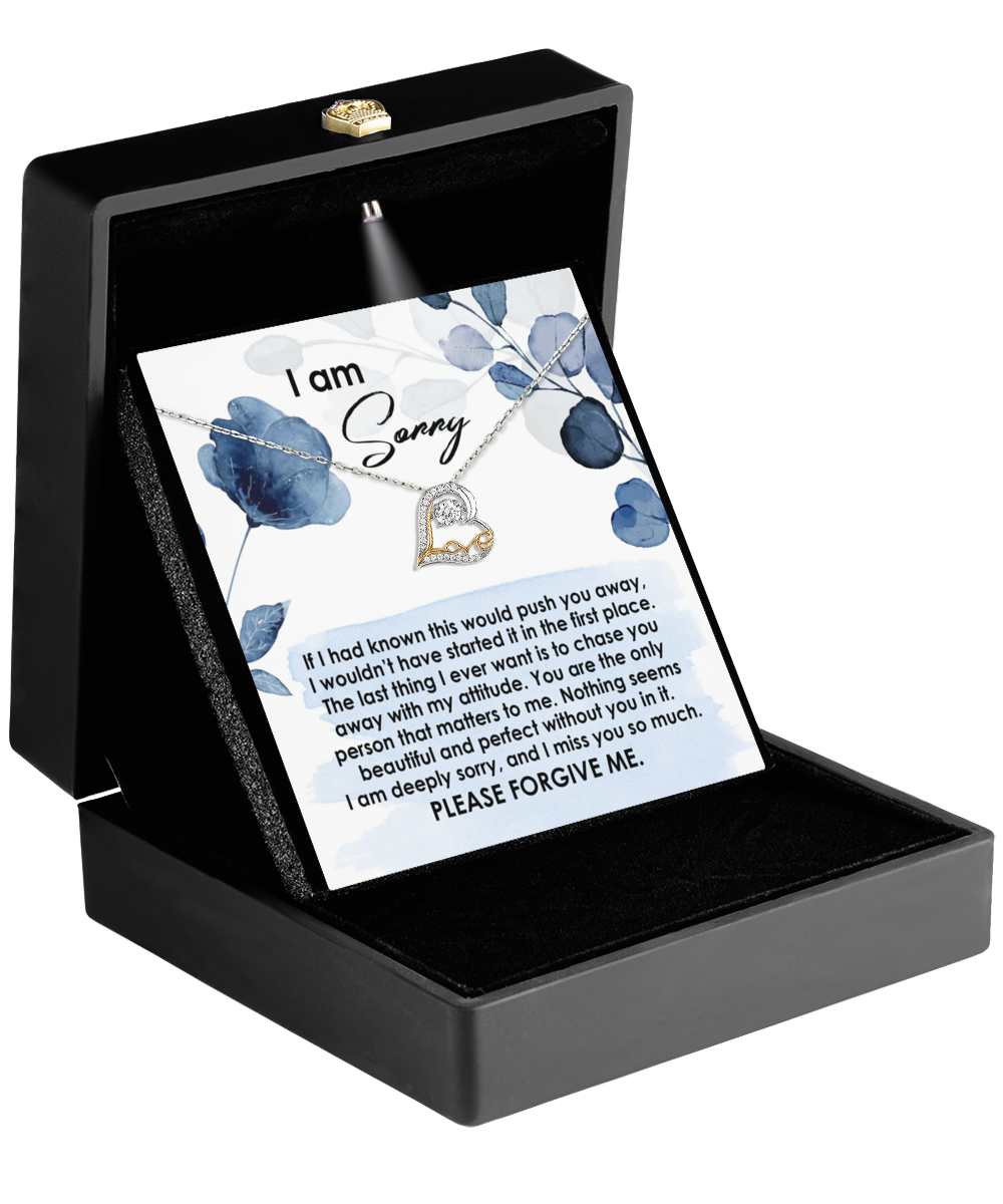 The "Sorry-Push You Away - Love Dancing Necklace" is a beautifully crafted, heart-shaped pendant made from sterling silver. Nestled inside a black box, it comes with an apology card that reads, "I am sorry," along with a heartfelt message asking for forgiveness. This elegant token is designed to gracefully and sincerely mend hearts.