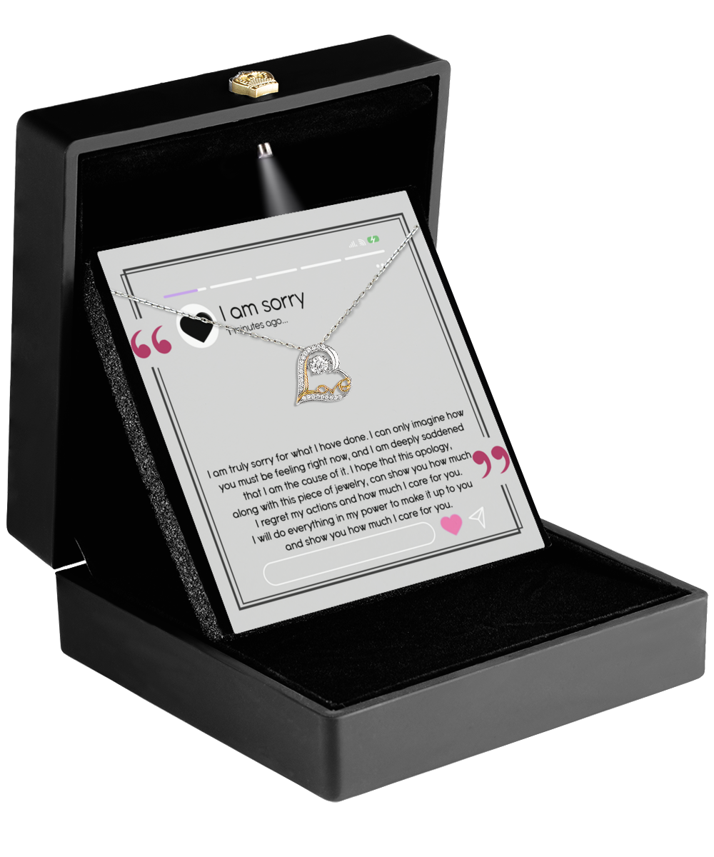 A sterling silver heart-shaped necklace, named the Sorry-Care For You - Love Dancing Necklace, is elegantly showcased in an open box with an apology message inscribed inside. The message conveys profound regret, love, and a promise to make things right.