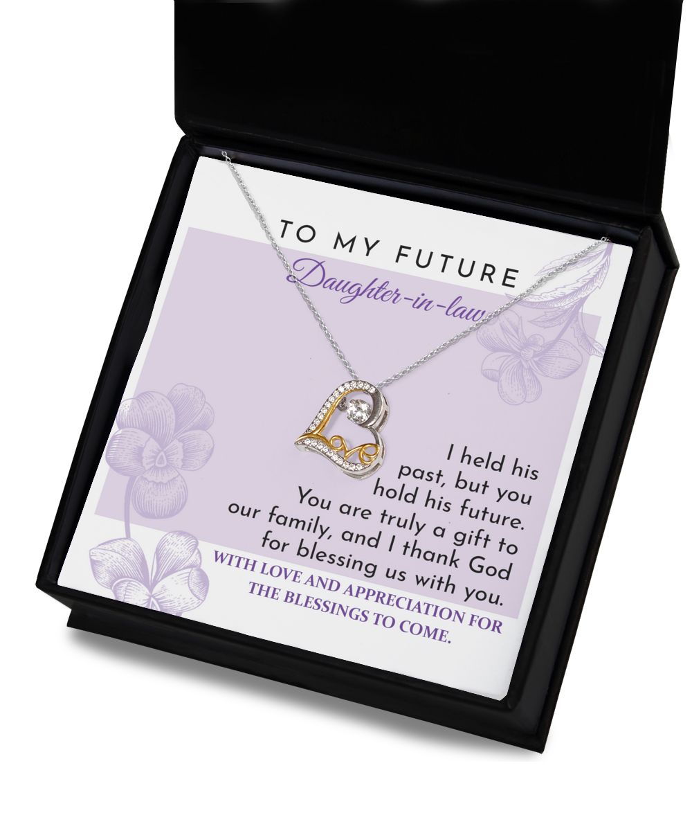 A "To Daughter-in-law, A Gift - Love Dancing Necklace" lies on top of a card in a black box. The card has a message expressing love and appreciation for a future daughter-in-law.