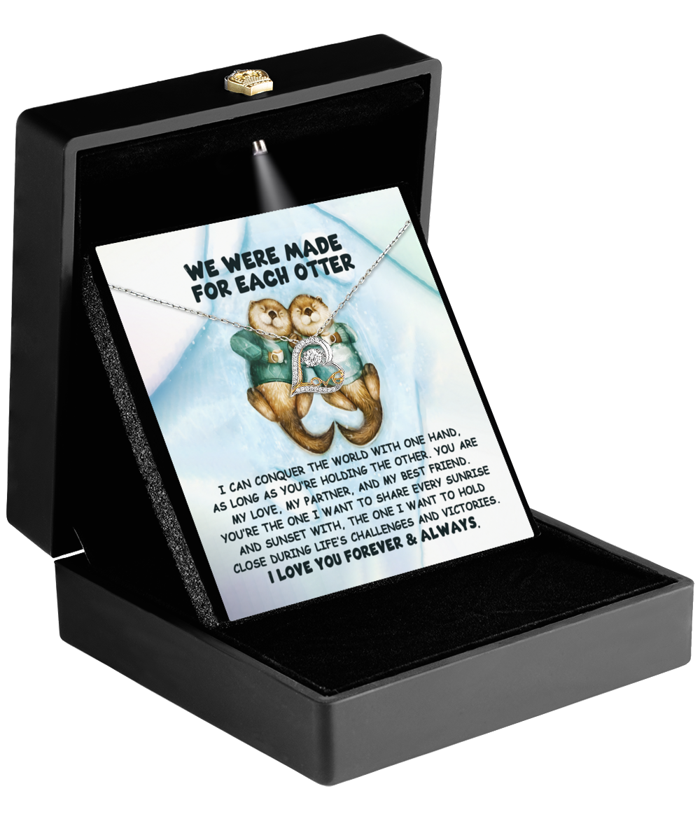 A 14k gold necklace elegantly presented in a black box, paired with a card showcasing two playful otters and a heartfelt message about love and companionship. This Soulmate- For Each Otter - Love Dancing Necklace is the perfect way to express affection, crafted to celebrate connections that shimmer like sterling silver tides.