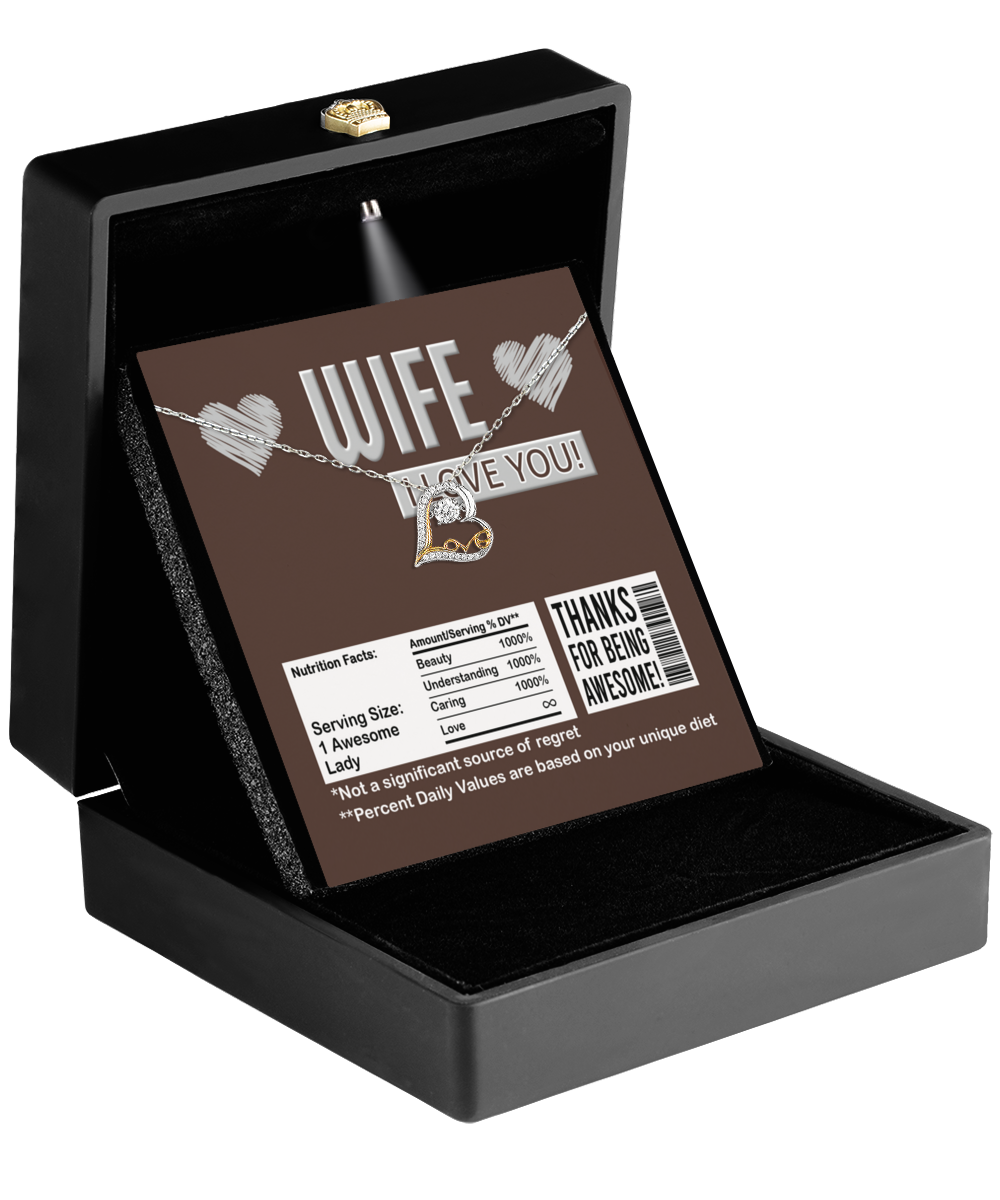 A black jewelry box presents the To Wife, Nutrition Facts - Love Dancing Necklace, accompanied by a card that playfully states, "Wife, I Love You," featuring humorous "nutrition facts" about awesomeness and beauty. This 14k gold pendant is the perfect gift for your wife.