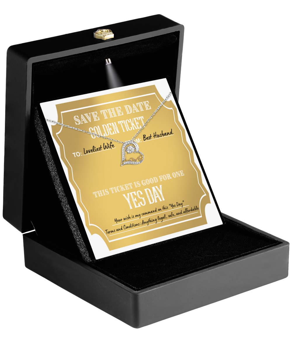 A black box unveils a glittering surprise: the To Wife-Golden Ticket packaged alongside a Love Dancing Necklace featuring a heart-shaped 14k gold pendant.