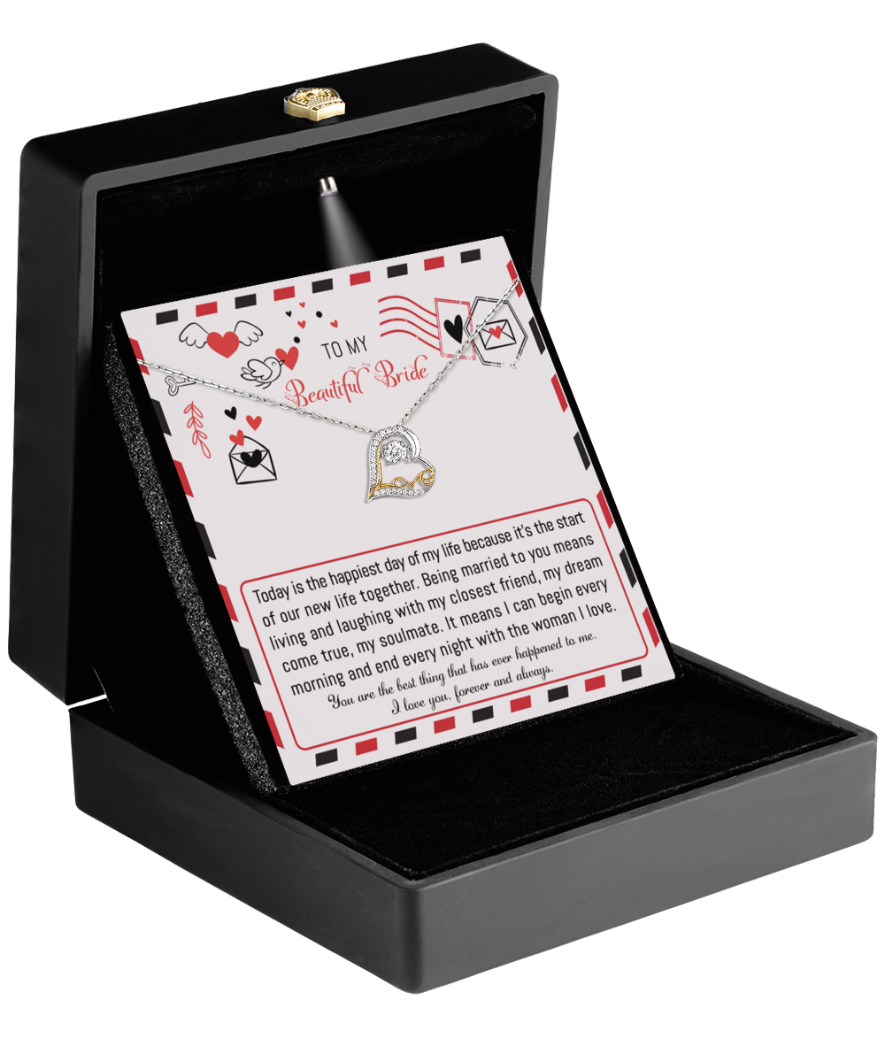 A jewelry box presents the "To Bride-The Happiest Day - Love Dancing Necklace," showcasing a heart-shaped pendant, along with a card addressed to "My Beautiful Bride." The card joyfully conveys love and enthusiasm for their marriage and future together, making it an ideal gift for the bride.