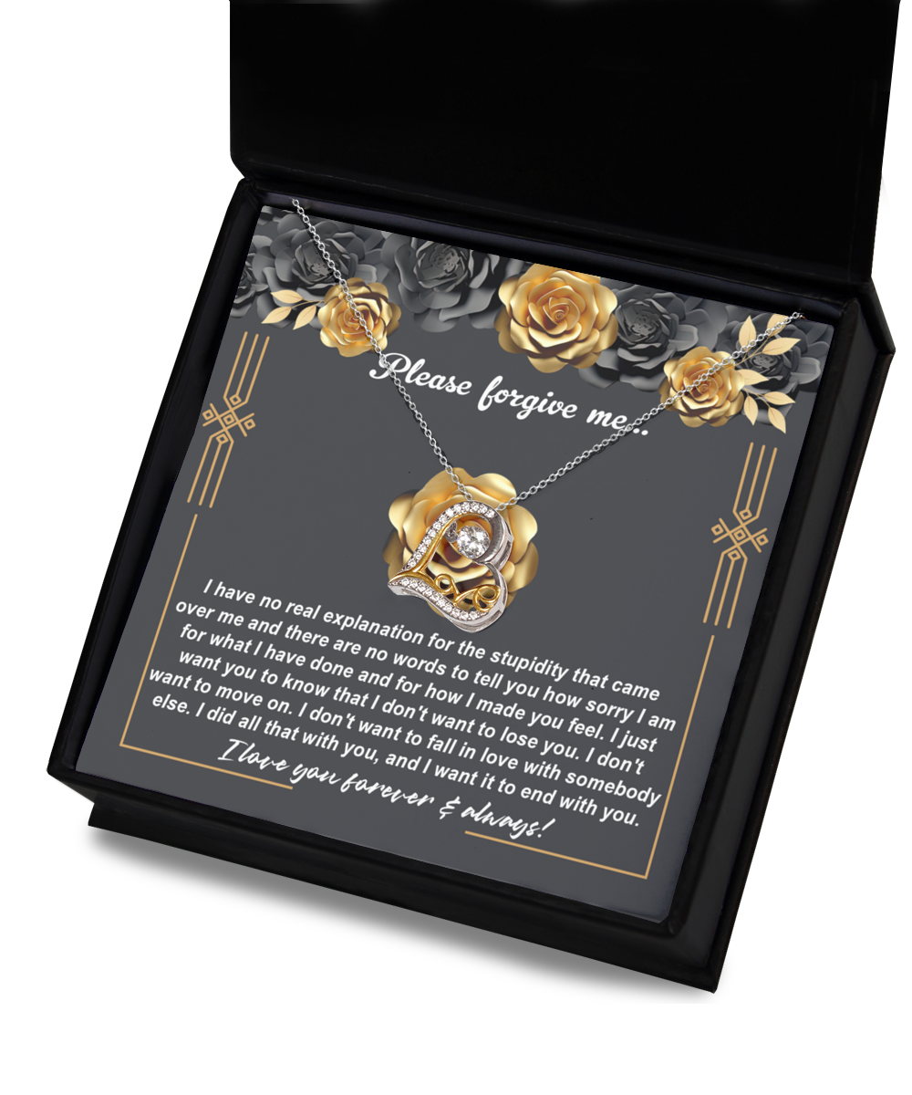 The "Sorry-End With You - Love Dancing Necklace," featuring a heart-shaped pendant, is elegantly displayed in a box. Inside the box, a note reads "Please forgive me" along with a heartfelt apology. The background is adorned with roses and gray floral decorations, adding an elegant touch.