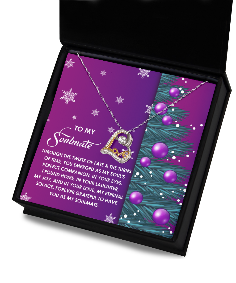 A box opens to reveal the Soulmate-Perfect Companion - Love Dancing Necklace, featuring a heart-shaped pendant crafted in 14k gold. It rests on a card that reads "To My Soulmate," adorned with purple ornaments and snowflakes, while the shimmering Cubic Zirconia centerpiece enhances its elegance.