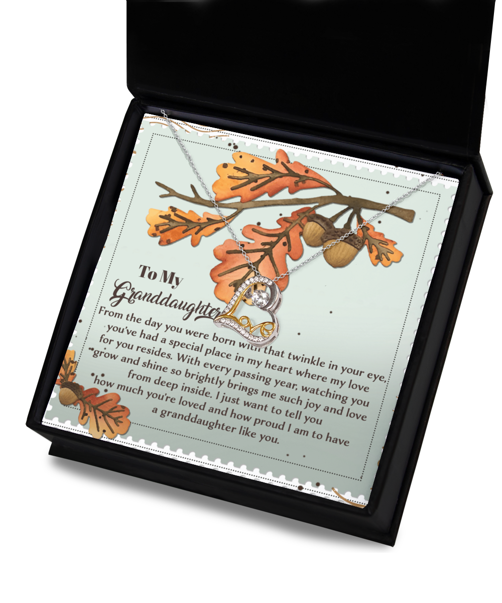 A Granddaughter-From Deep Inside - Love Dancing Necklace, elegantly crafted in sterling silver and thoughtfully presented in a gift box featuring a heartfelt message embellished with autumn leaves and acorns, making it an ideal gift for a cherished granddaughter.