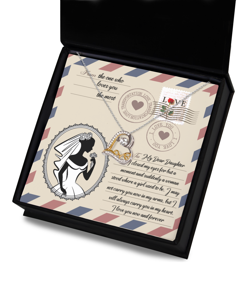 A Daughter Wedding-In My Arms - Love Dancing Necklace is displayed in a box with a decorative card. The card features a silhouette of a bride, stamps, and a heartfelt message to a daughter from a parent.