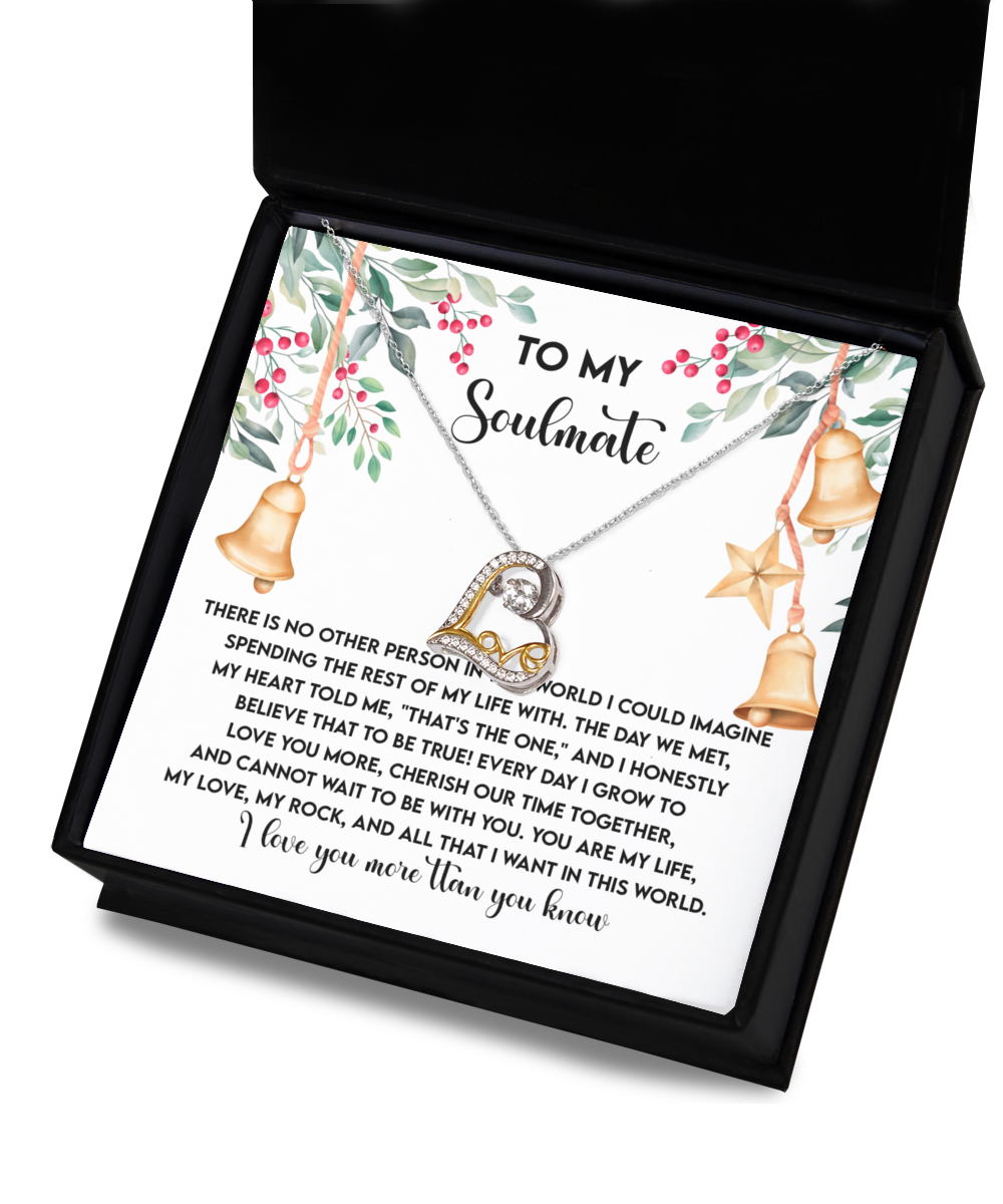 Displayed in an open gift box is the Soulmate-Be With You - Love Dancing Necklace featuring a heart pendant. Made from sterling silver, it sparkles with elegance. The accompanying card reads "To My Soulmate" and includes a heartfelt message.