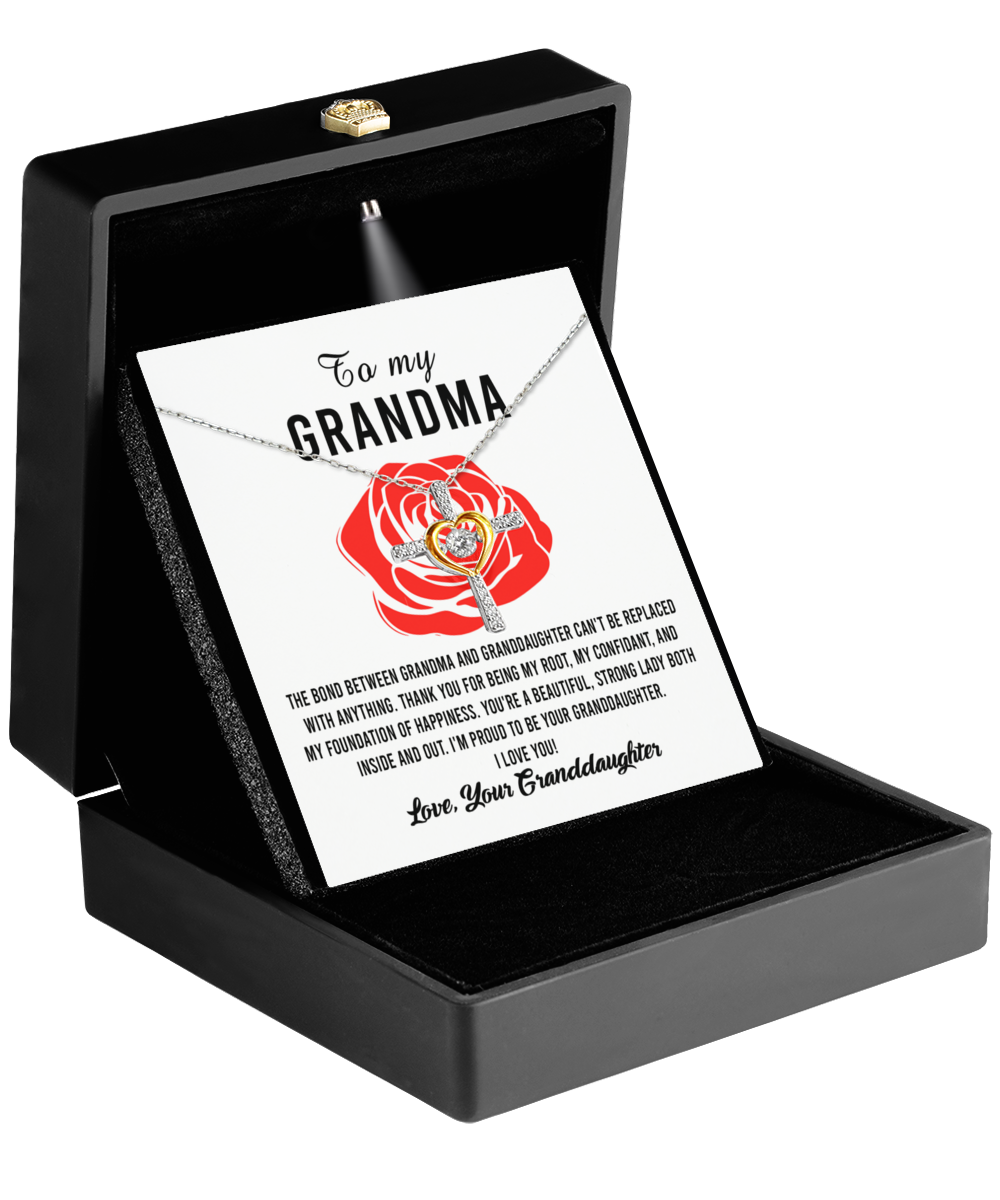 A "To Grandma, Strong Lady - Cross Dancing Necklace" by Gearbubble in a gift box with a sentimental message card for a grandmother from a grandchild.