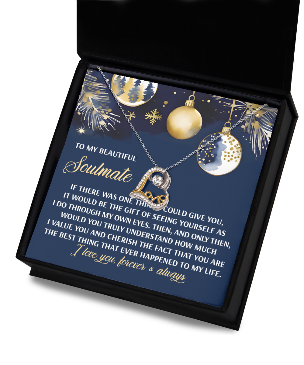 A Soulmate-One Thing - Love Dancing Necklace in sterling silver, accompanied by a heartfelt message, nestles in a festive gift box adorned with holiday-themed decorations and ornaments.