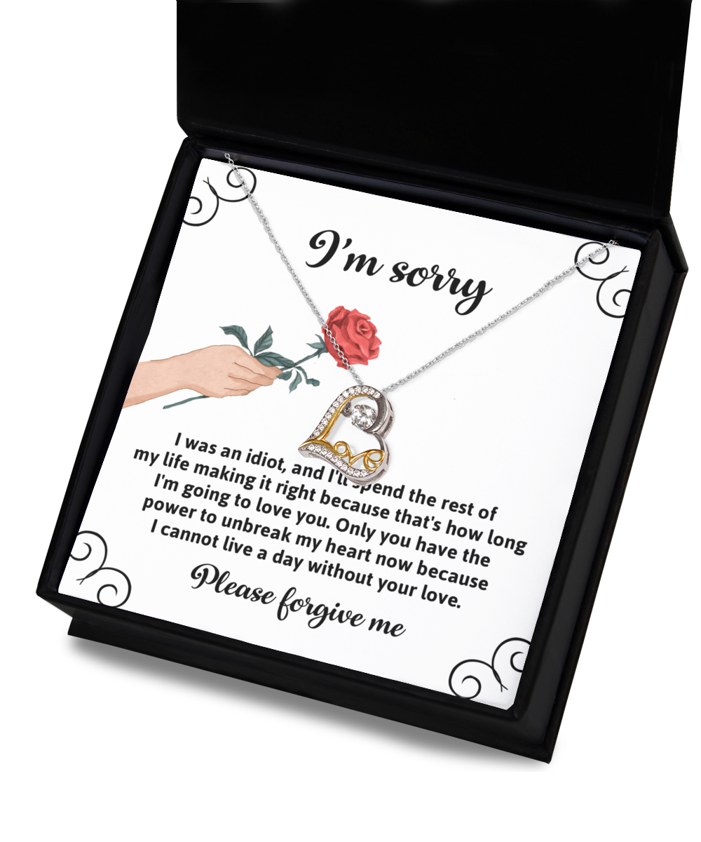 A Sorry-Making It Right - Love Dancing Necklace, featuring a red rose and heart-shaped design crafted in 14k gold, is displayed above an apology note with the text: "I'm sorry. Please forgive me.