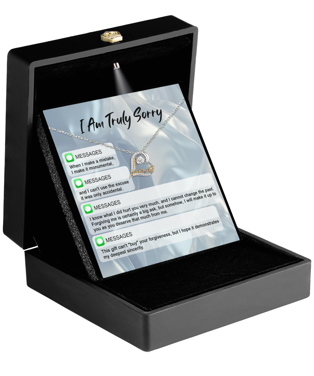 The Sorry-Make A Mistake - Love Dancing Necklace features a 14k gold heart-shaped pendant and comes in a black box with a card that reads "I Am Truly Sorry" and message bubbles for heartfelt apologies—perfect for meaningful moments.