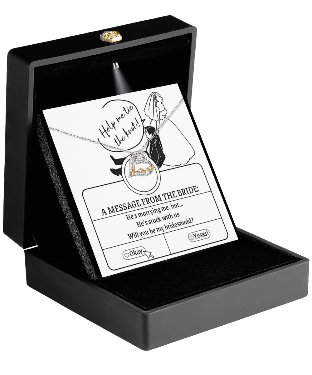 An open black jewelry box reveals the stunning Bridesmaid-Stuck With Us - Love Dancing Necklace, accompanied by a card featuring a humorous bride illustration and the question: Will you be my bridesmaid? This charming gift is sure to delight your bridesmaids.