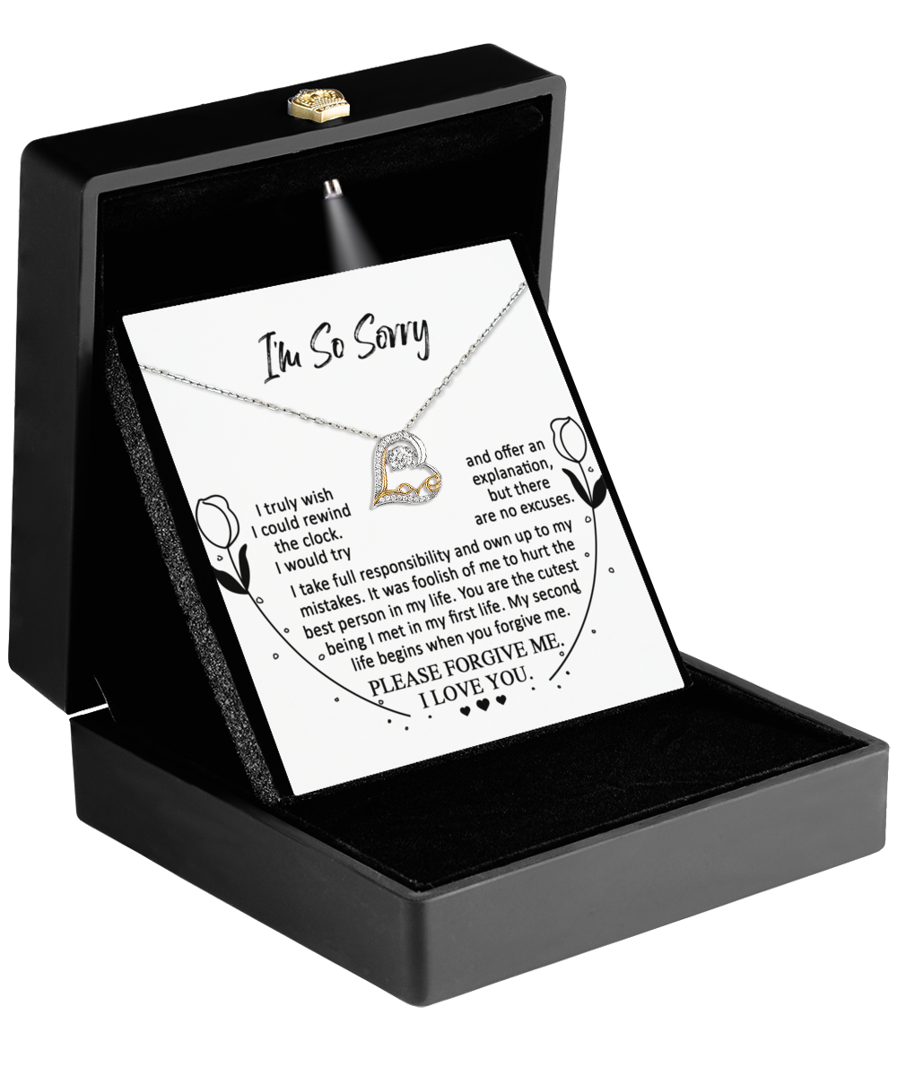 A Sorry-My First Life - Love Dancing Heart-Shaped Rhodium-Plated Pendant Necklace in a box, accompanied by an apology note reading "I'm So Sorry" above a heartfelt message.