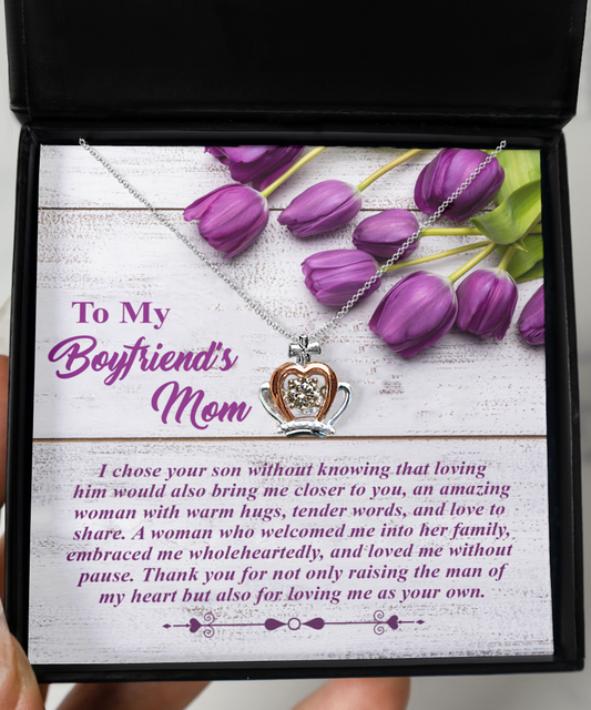 A heart-shaped crown pendant necklace in a gift box with a message of gratitude to a boyfriend's mother, accompanied by purple tulips from Gearbubble.