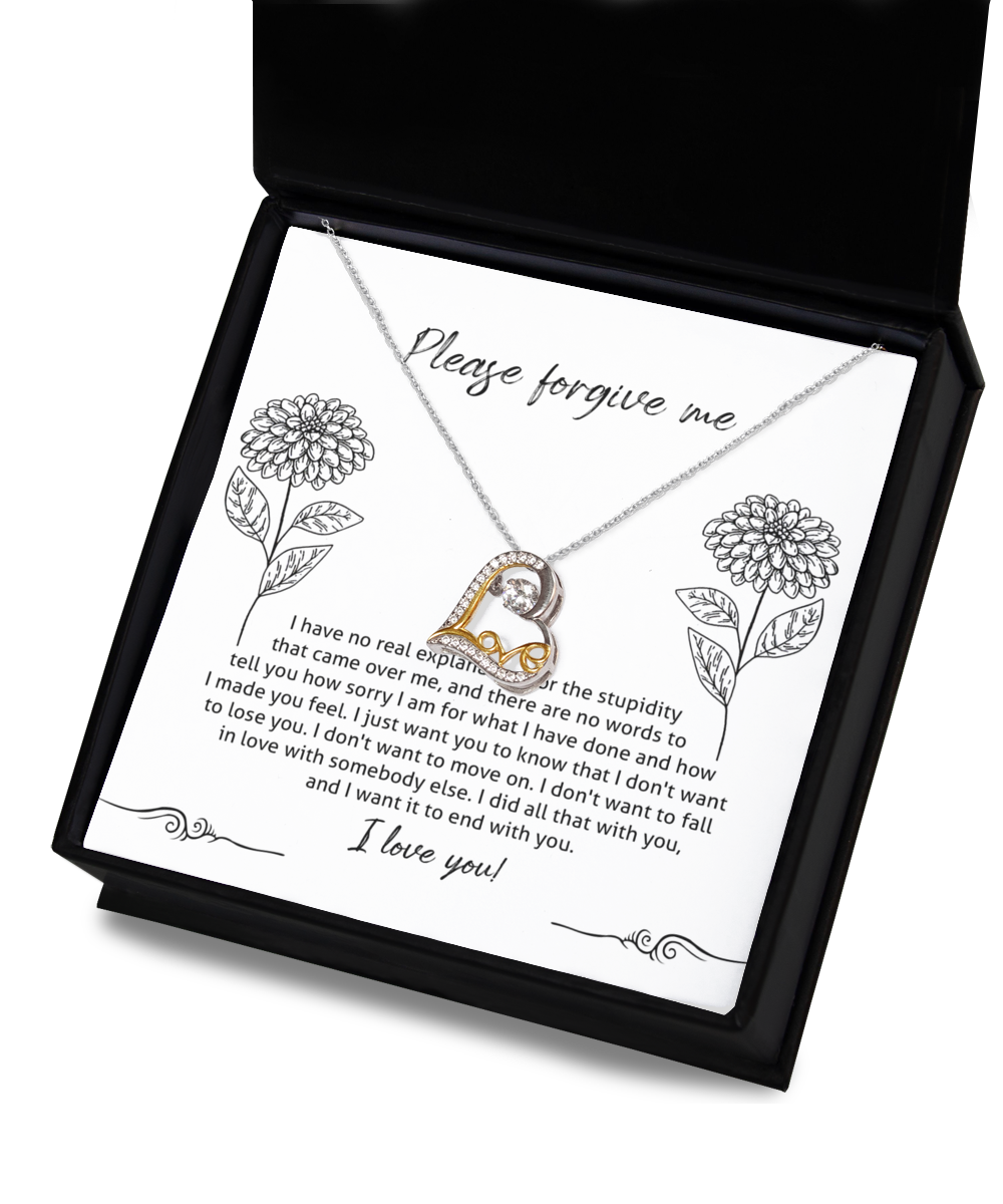 The Sorry-Real Explanation - Love Dancing Necklace, crafted from sterling silver with a heart-shaped pendant, is placed inside a box. The inner lid of the box features an apology message surrounded by flower illustrations.