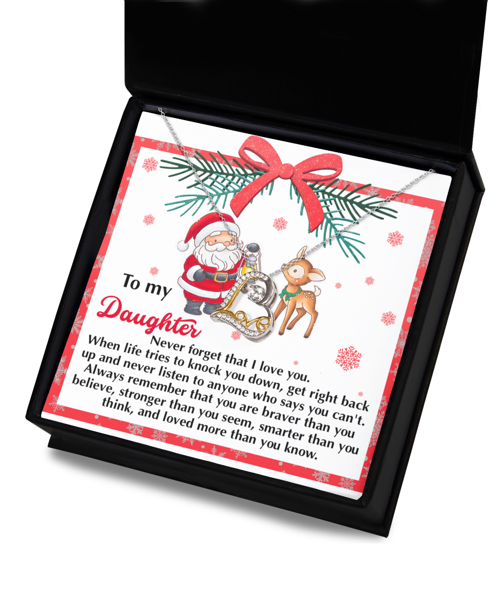 A Daughter-Get Back Up - Love Dancing Necklace, crafted from Sterling Silver, comes elegantly presented in a box with a card displaying Santa and a reindeer. The card conveys an inspirational message to a daughter about love and resilience, making it an ideal gift for the holiday season.