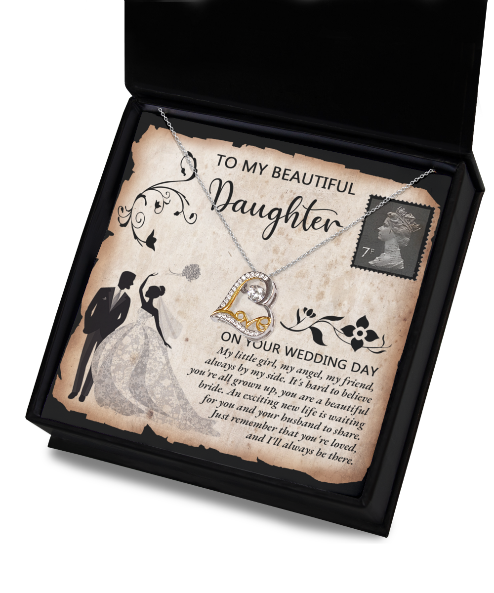 A Daughter Wedding-Beautiful Bride - Love Dancing Necklace featuring a heart-shaped pendant sits elegantly in a gift box with a heartfelt message for a daughter on her wedding day. Crafted from 14k gold, the necklace is accompanied by an illustration of a bride and groom within a decorative border.