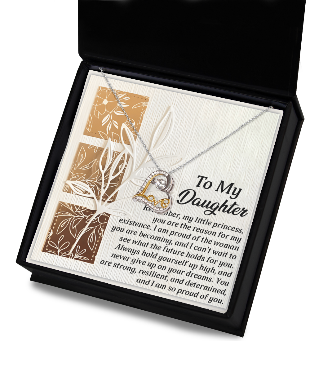 The Daughter-Holds For You - Love Dancing Necklace is an elegant piece featuring a pendant elegantly displayed in a box, crafted from sterling silver. Accompanied by a heartfelt message card specifically for your daughter, it beautifully conveys pride and encouragement.