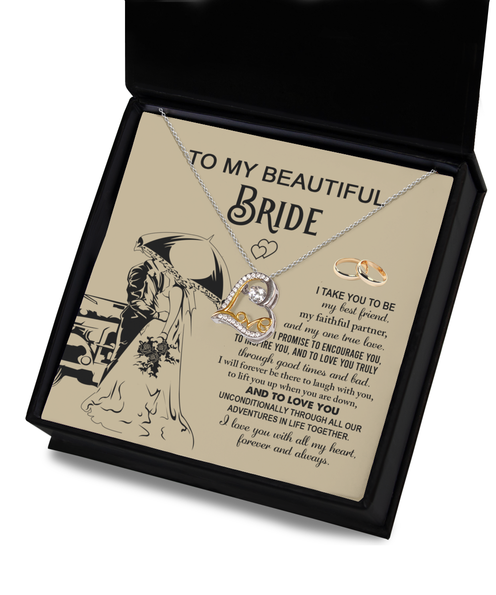 A sterling silver Bride-Faithful Partner - Love Dancing Necklace and two rings are elegantly displayed in a box with a heartfelt message for the bride, featuring vows of love, support, and encouragement. The illustration of a couple under an umbrella adds a romantic touch.