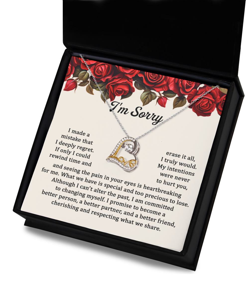 The "Sorry-Profound And True - Love Dancing Necklace," a stunning sterling silver piece with a heart-shaped pendant, is displayed on a background adorned with a red rose design and accompanied by an apology message expressing regret, commitment to change, and a promise to be better.