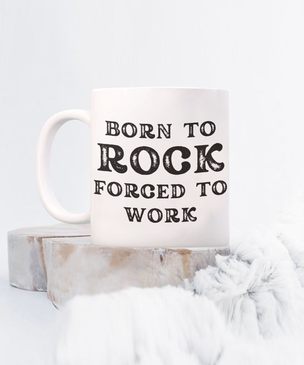 The "Born to Rock Forced to Work" Coffee Mug, perfect for rockers, features bold text on a white surface. Printed and shipped from the USA for a limited time, it offers guaranteed safe checkout. Ideal gift or appreciation cup for any rocker!.