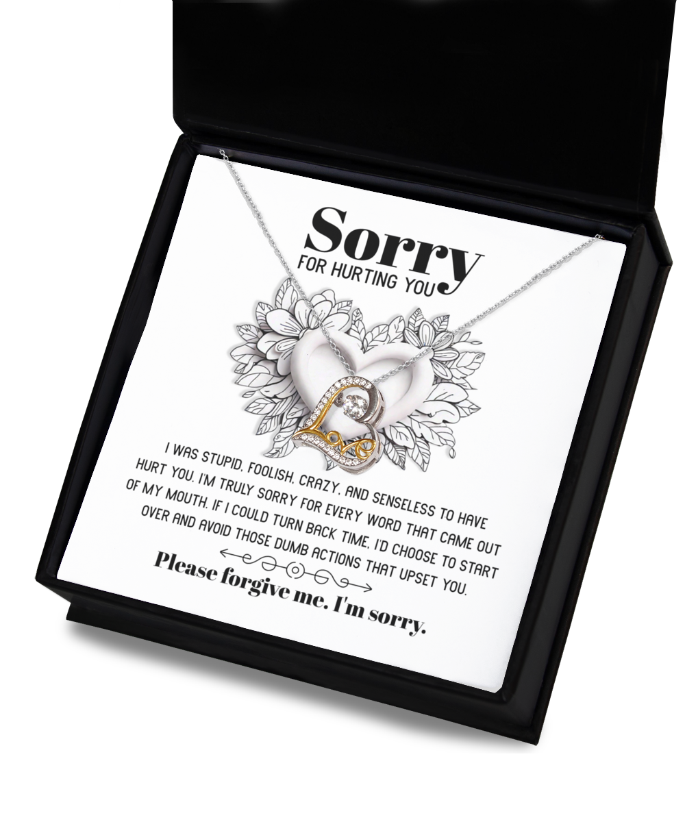 A stunning heart-shaped necklace, the Sorry-Turn Back Time - Love Dancing Necklace, featuring 14k gold plating and accompanied by a heartfelt note expressing an apology for past actions and a plea for forgiveness.