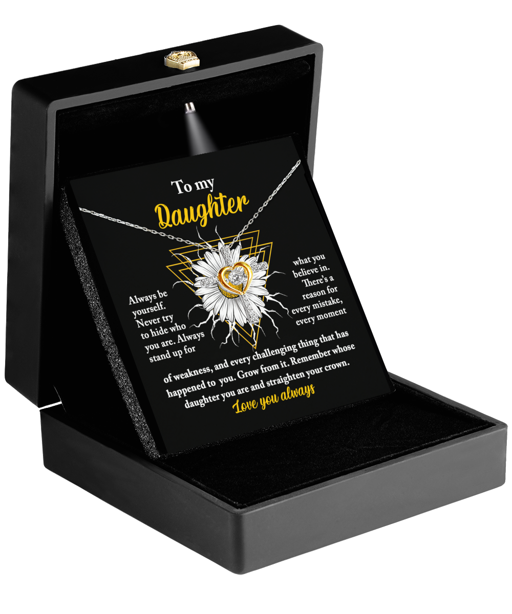 An open black jewelry box displays a "To Daughter-Be Yourself - Cross Dancing Necklace" made of .925 Sterling Silver. Inside the lid is a heartfelt message to a daughter in white and yellow text on a black background, adorned with a sunflower image.