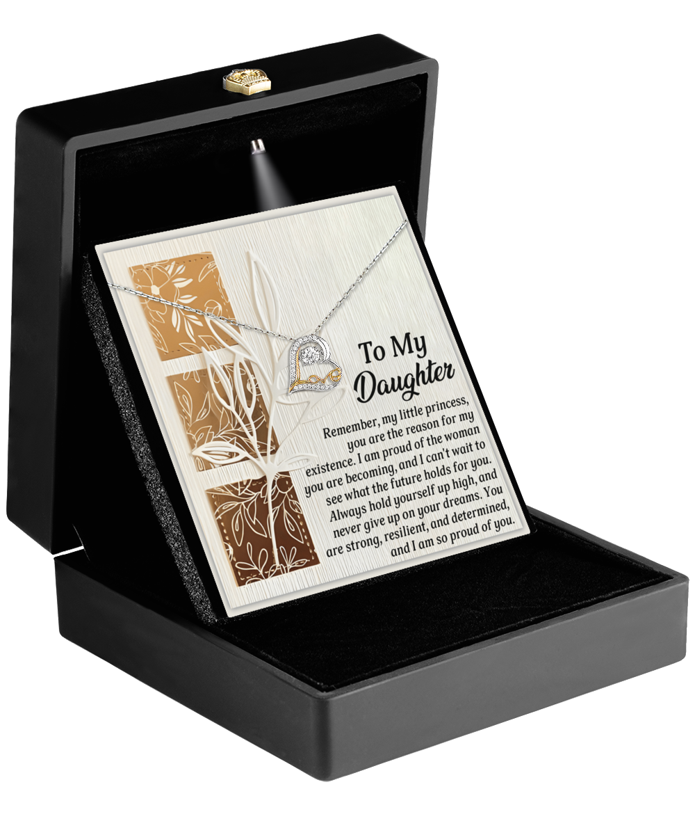 The Daughter-Holds For You - Love Dancing Necklace comes in a black box, showcasing a heart pendant adorned with an engraved message titled "To My Daughter" and embellished with floral design accents. Crafted from sterling silver, this necklace offers a timeless touch.