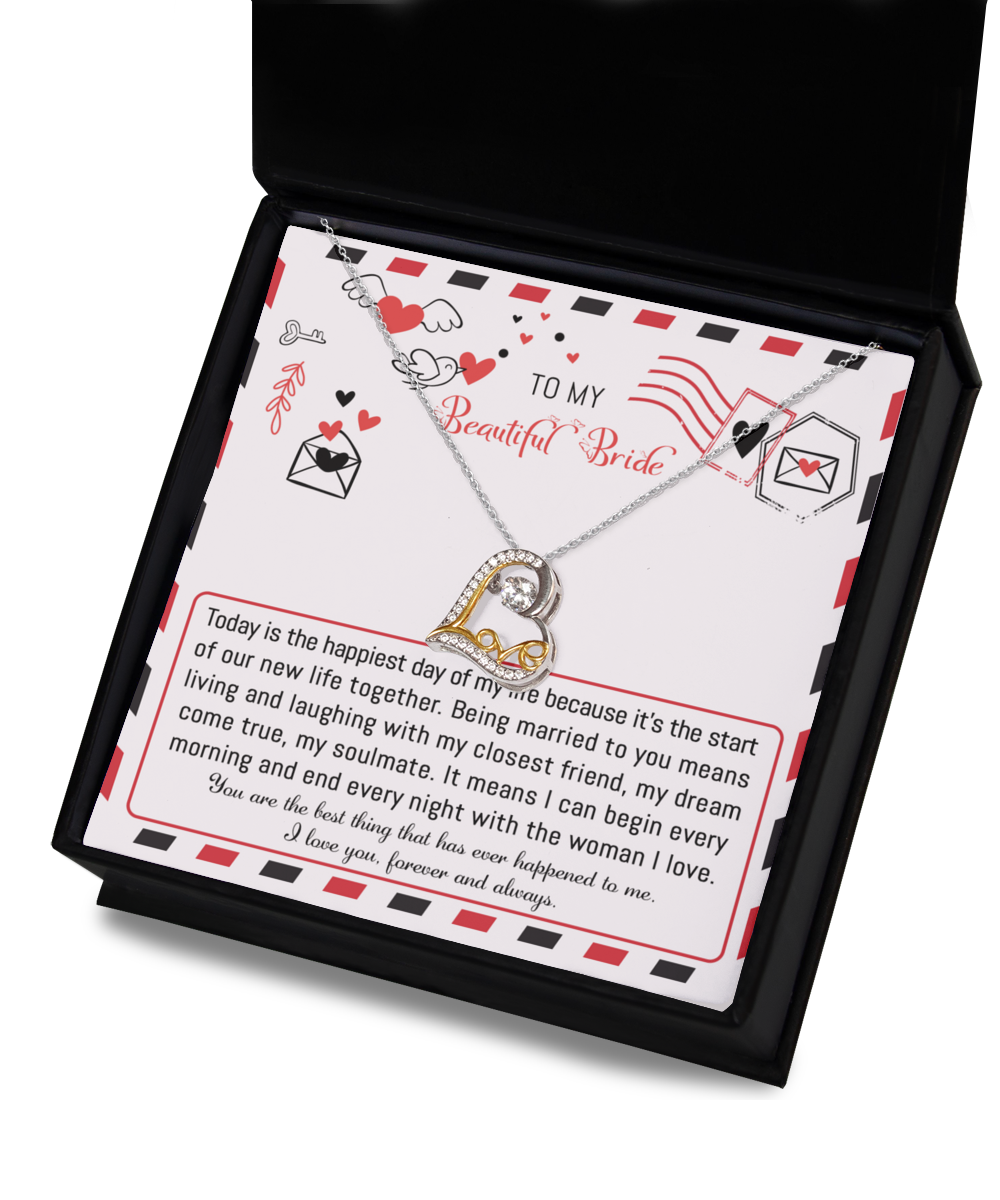 The "To Bride-The Happiest Day - Love Dancing Necklace," available in sterling silver or 14k gold for timeless elegance, comes with a card that delivers a romantic message to "my beautiful bride" about love, happiness, and a shared future. This heart-shaped necklace is elegantly presented inside a black jewelry box.