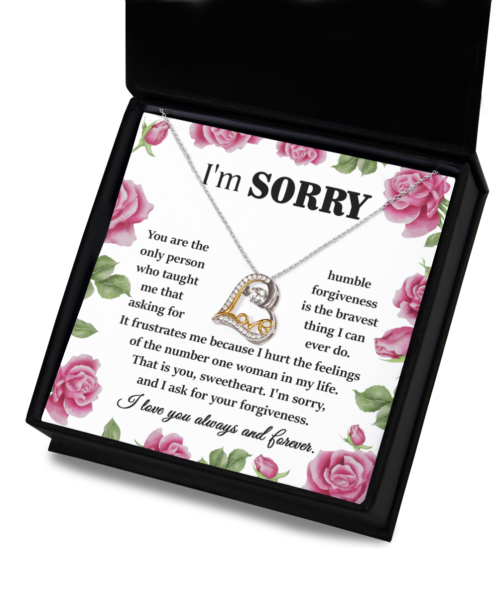 A gift box containing the Sorry-Your Forgiveness - Love Dancing Necklace, crafted in .925 sterling silver, along with an apology note adorned with a floral border. The note conveys regret and asks for forgiveness, highlighting the importance of humility and love.