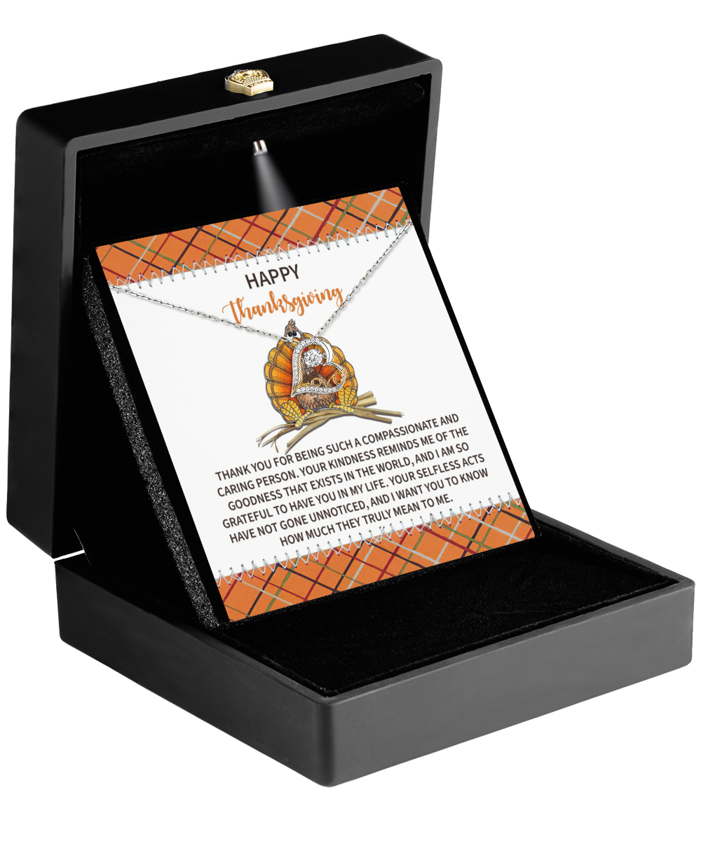 The Thanksgiving-In My Life - Love Dancing Necklace, made from 14k gold, is elegantly presented in an open black jewelry box alongside a Thanksgiving-themed card.