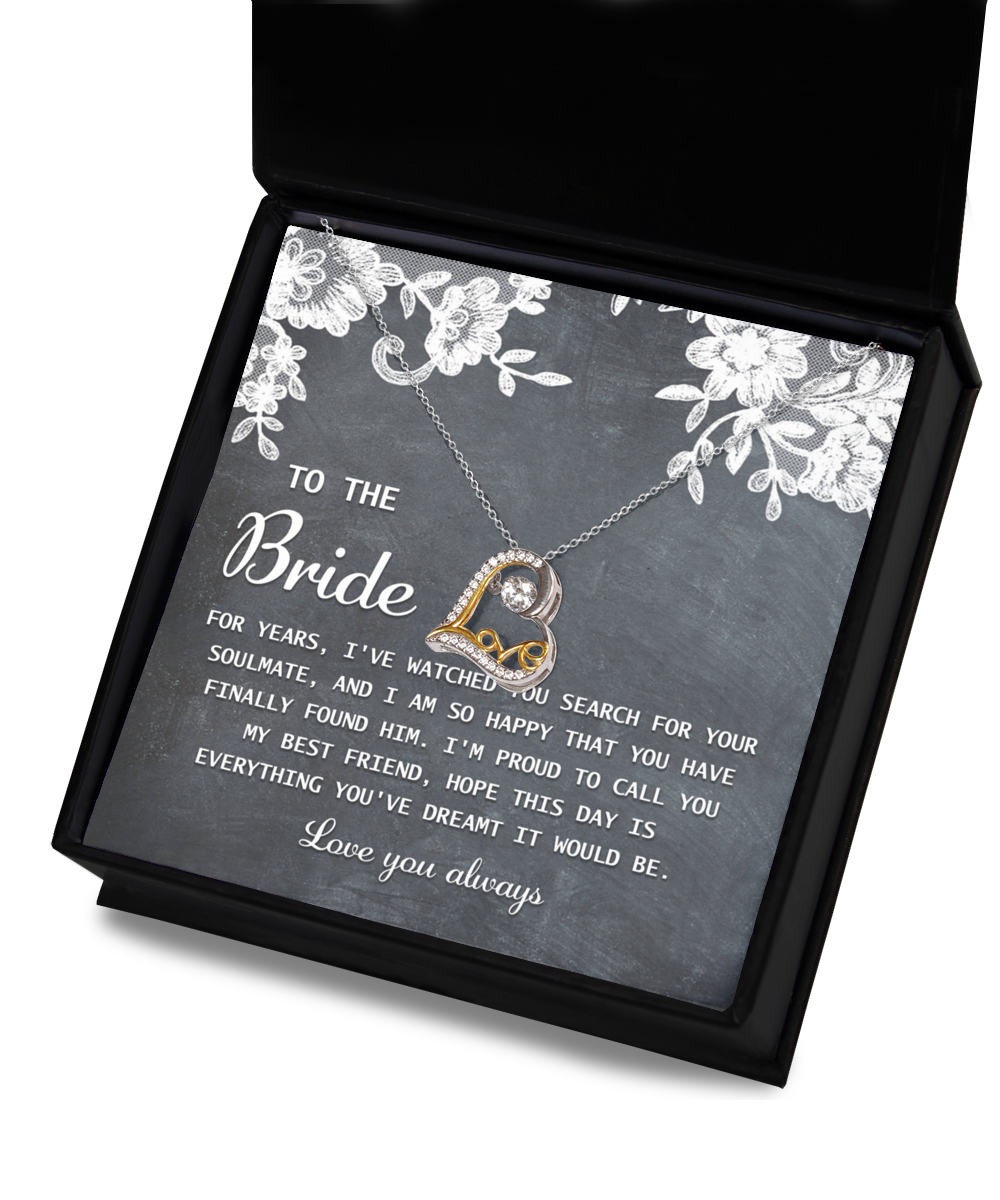 A heart-shaped 14k gold "To Bride-My Best Friend - Love Dancing Necklace" rests atop a card with a message to the bride, expressing joy for finding her soulmate and wishing the day to be everything she dreamed of.