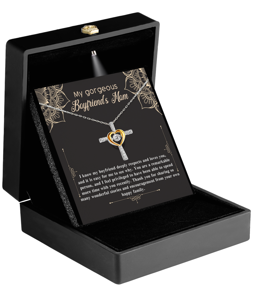 A "To Boyfriend's Mom, Happy Family - Cross Dancing Necklace" with a heart-shaped pendant in a gift box, accompanied by a message addressed to a boyfriend's mother. This product is by Gearbubble.