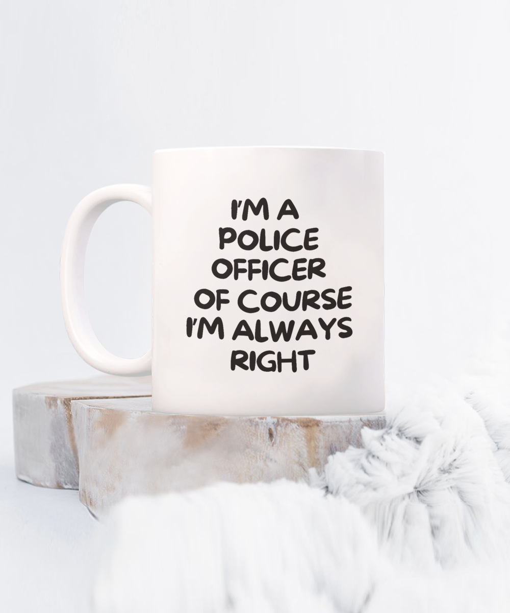 The "I'm A Police Officer Of Course I'm Always Right" coffee mug, printed and shipped from the USA, sits on coasters with soft fabric nearby. Available for a limited time, it's a perfect gift idea and appreciation cup for police officers.