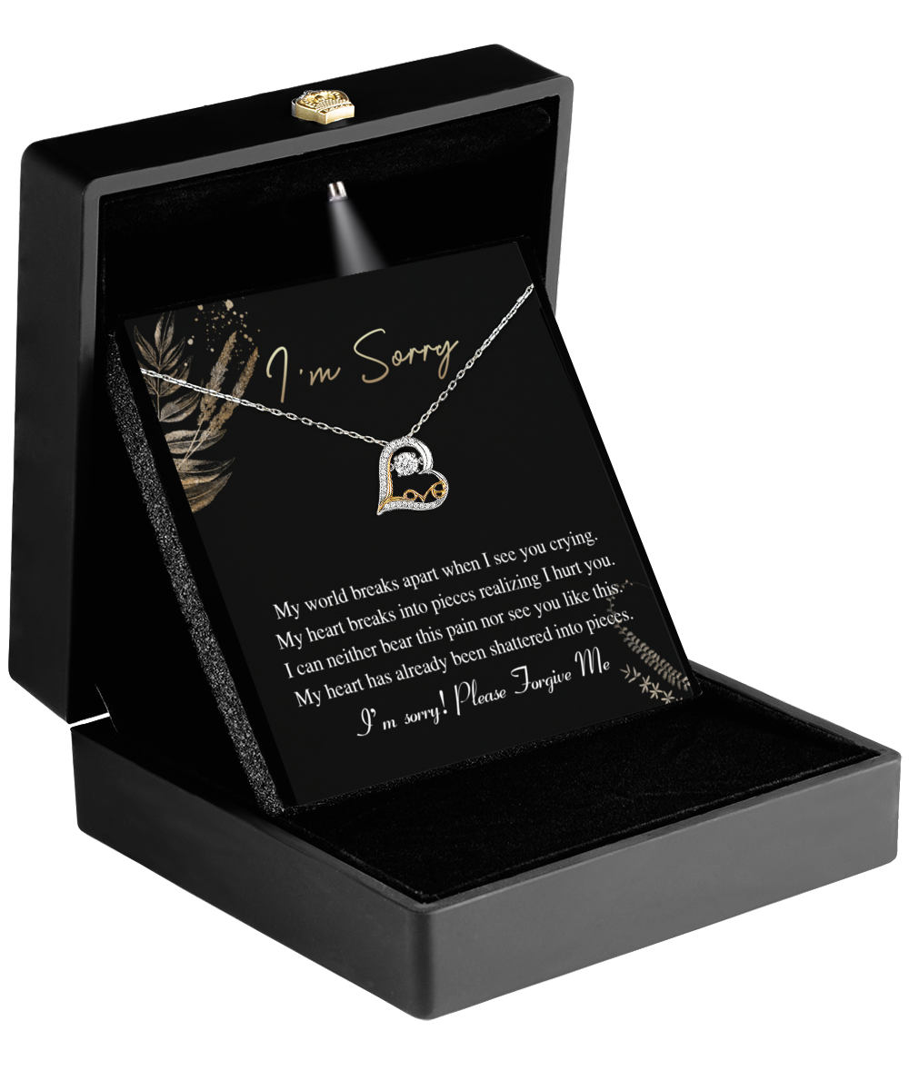 A black jewelry box contains the Sorry-See You Crying - Love Dancing Necklace, featuring a 14k gold heart-shaped pendant with a diamond accent and an apology card, making it the perfect gift for your wife.