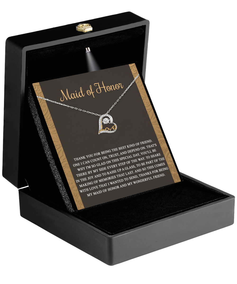 The "To Maid of Honor-Kind Of Friend - Love Dancing Necklace," crafted in 14k gold with a heart-shaped pendant, is elegantly displayed in an open black jewelry box along with an appreciation card.