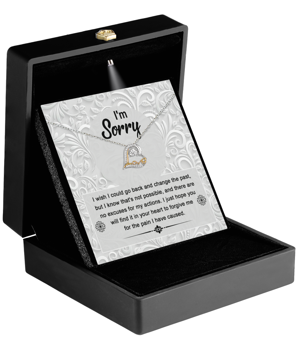 A jewelry box with an open lid showcases the "Sorry-Change The Past - Love Dancing Necklace," a 14k gold heart-shaped pendant, accompanied by a card that reads "I'm Sorry" and features an apology message below.